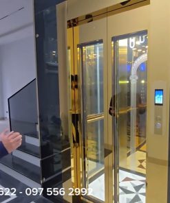 THANG MÁY KÍNH GIA ĐÌNH INOX GƯƠNG VÀNG: SỰ KẾT HỢP HOÀN HẢO GIỮA CÔNG NGHỆ VÀ NGHỆ THUẬT